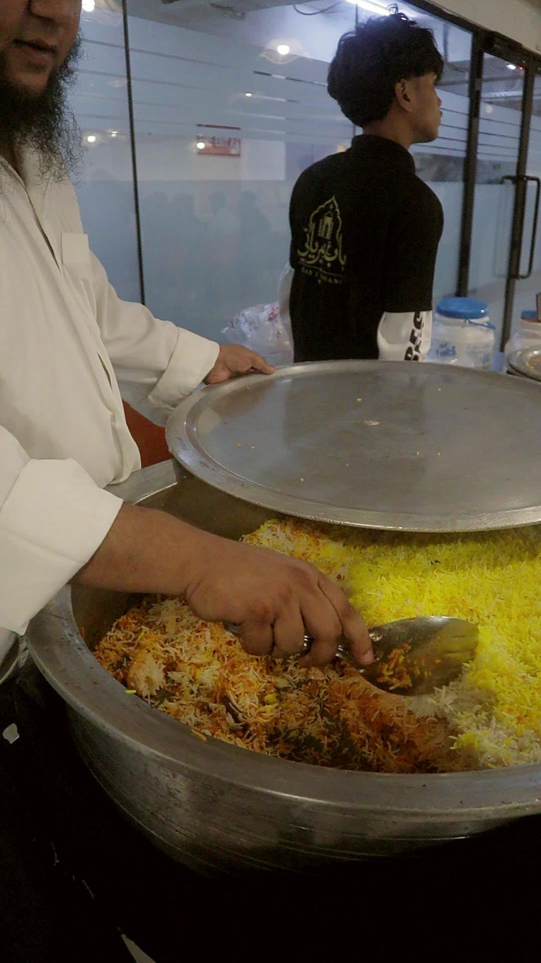 Chef breaking open a sealed handi of biryani at an office event